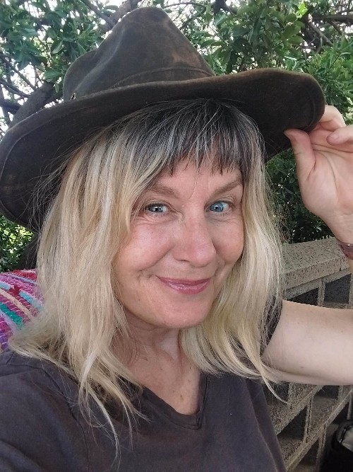 Susanne Bernt smiling outdoors in a sun hat